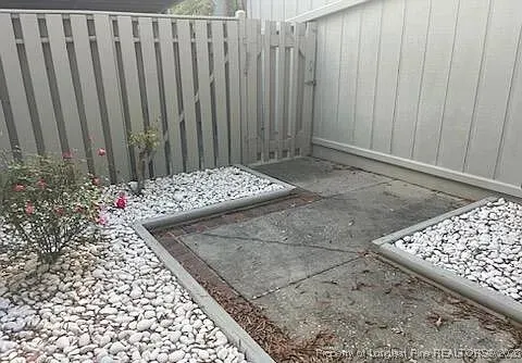 a view of a livingroom with wooden floor and a large window