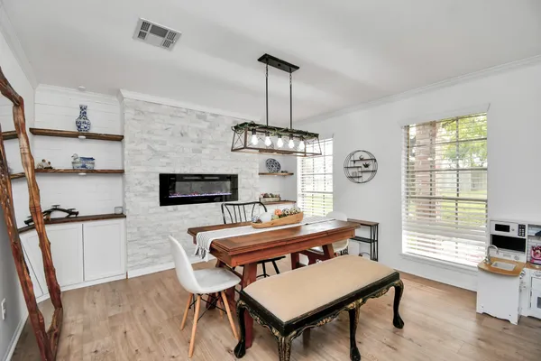 a living room with furniture a chandelier and a wooden floor