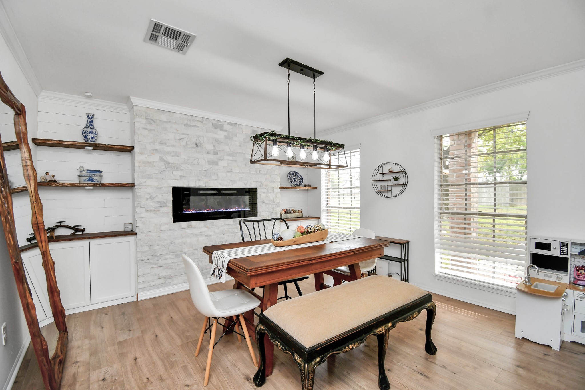 7502 Ralick Court Spring, TX 77379 - Photo 11 of 43 a dining room with furniture a chandelier and wooden floor