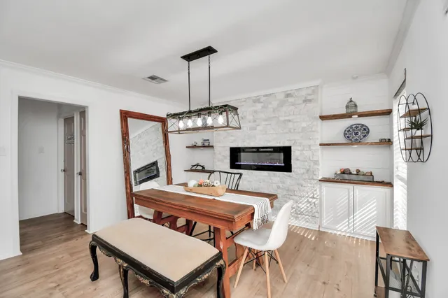 a living room with furniture a chandelier and a wooden floor