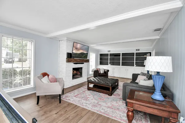 a living room with furniture and a fireplace