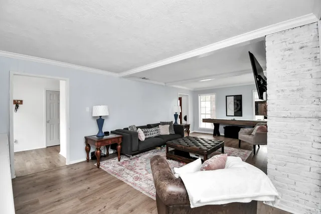 a living room with furniture and wooden floor