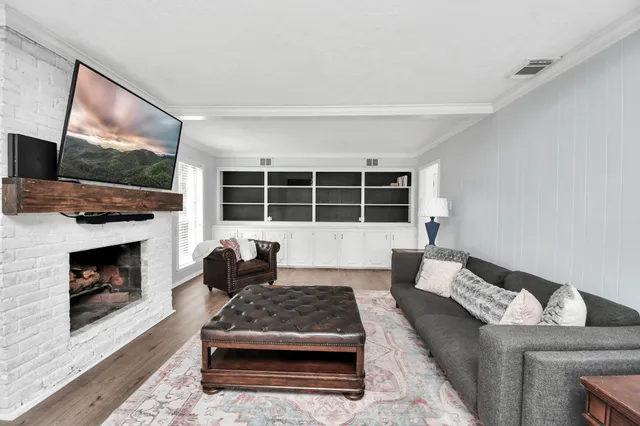 a living room with furniture and a fireplace