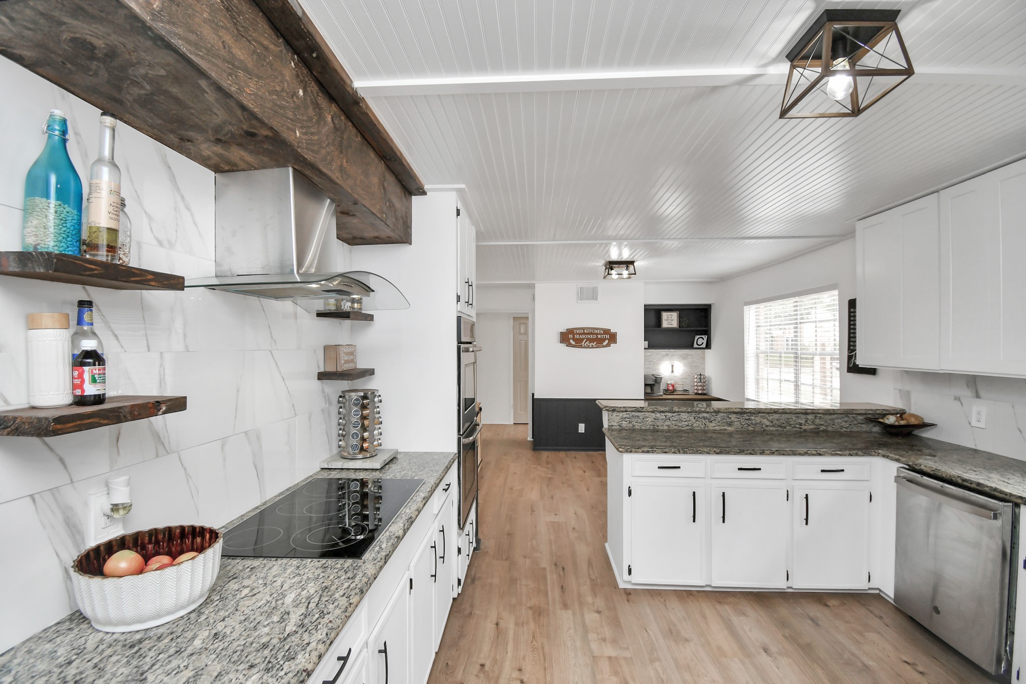 7502 Ralick Court Spring, TX 77379 - Photo 20 of 43 a kitchen with granite countertop a sink a stove and cabinets