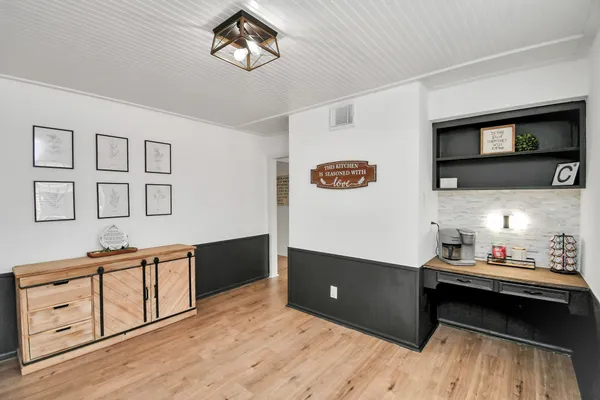 a spacious bedroom with a bed and a flat screen tv