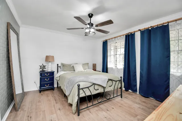 a bedroom with a bed and window