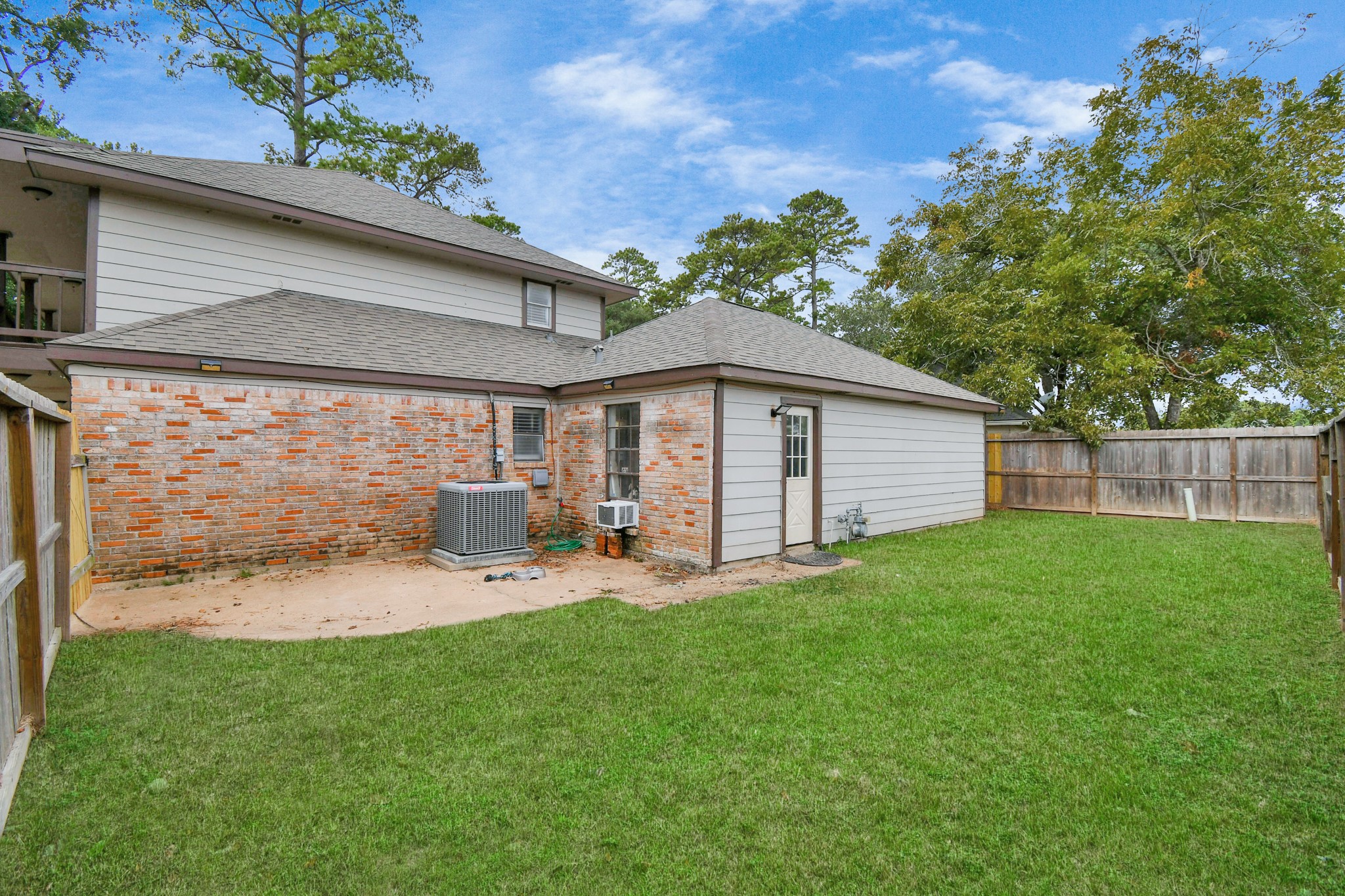 7502 Ralick Court Spring, TX 77379 - Photo 40 of 43 a backyard of a house with table and chairs plants and large tree