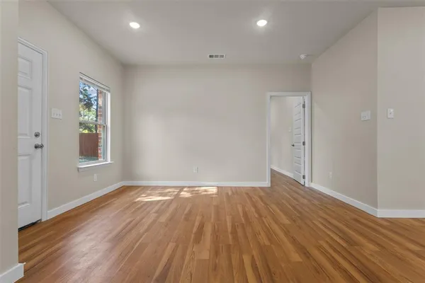 a kitchen with stainless steel appliances granite countertop a sink cabinets and wooden floor