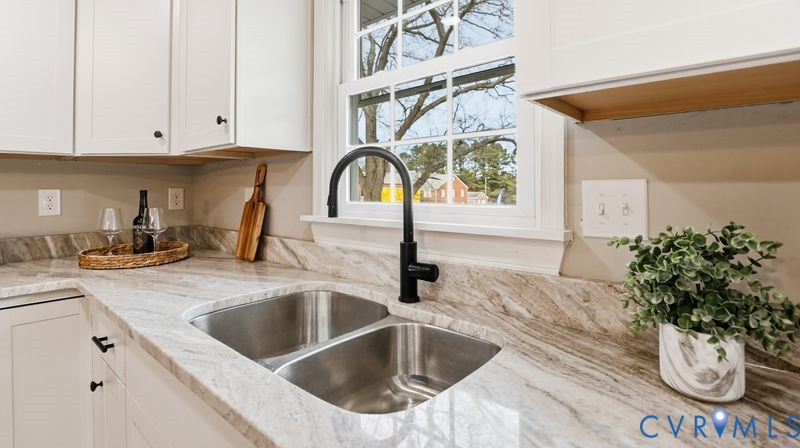 25209 Ritchie Avenue Petersburg, VA 23803 - Photo 12 of 50 Kitchen with light stone countertops and white cab