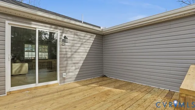 a view of a backyard space with wooden floor and a potted plant