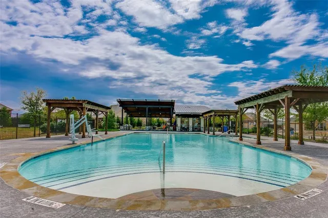 swimming pool view with a yard