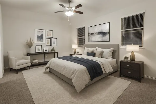 a bedroom with a bed and lamp on desk
