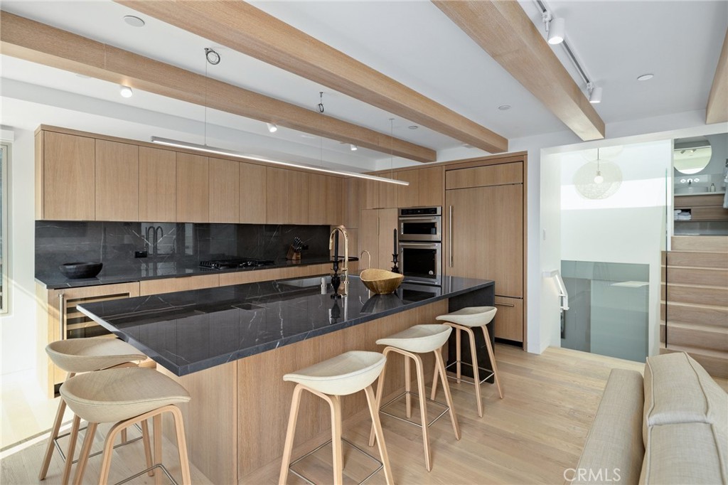 4310 Ocean Drive Manhattan Beach, CA 90266 - Photo 22 of 54 a kitchen with stainless steel appliances kitchen island granite countertop a table chairs and a refrigerator