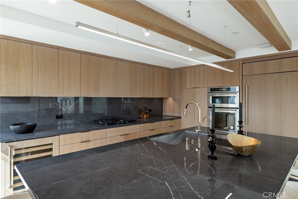 4310 Ocean Drive Manhattan Beach, CA 90266 - Photo 23 of 54 a kitchen with a sink and a stove top oven