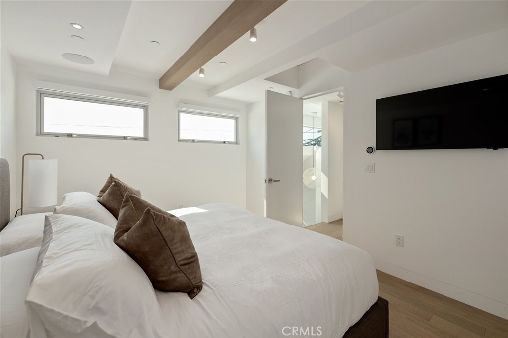 4310 Ocean Drive Manhattan Beach, CA 90266 - Photo 31 of 54 a bedroom with a large bed and a flat screen tv