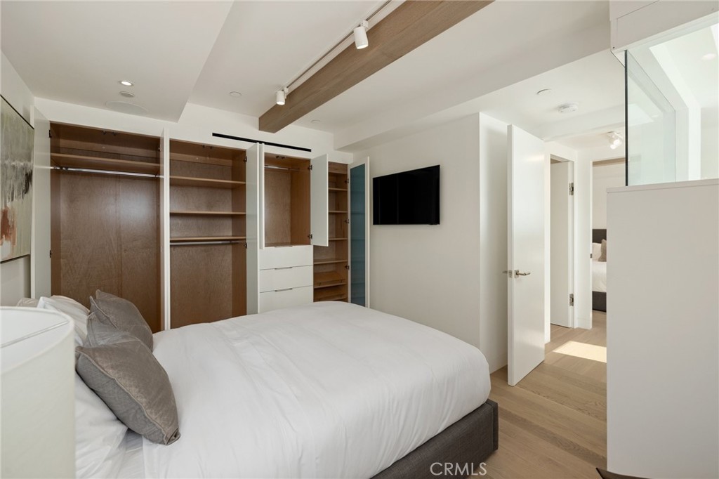 4310 Ocean Drive Manhattan Beach, CA 90266 - Photo 35 of 54 a bedroom with a bed and a flat screen tv