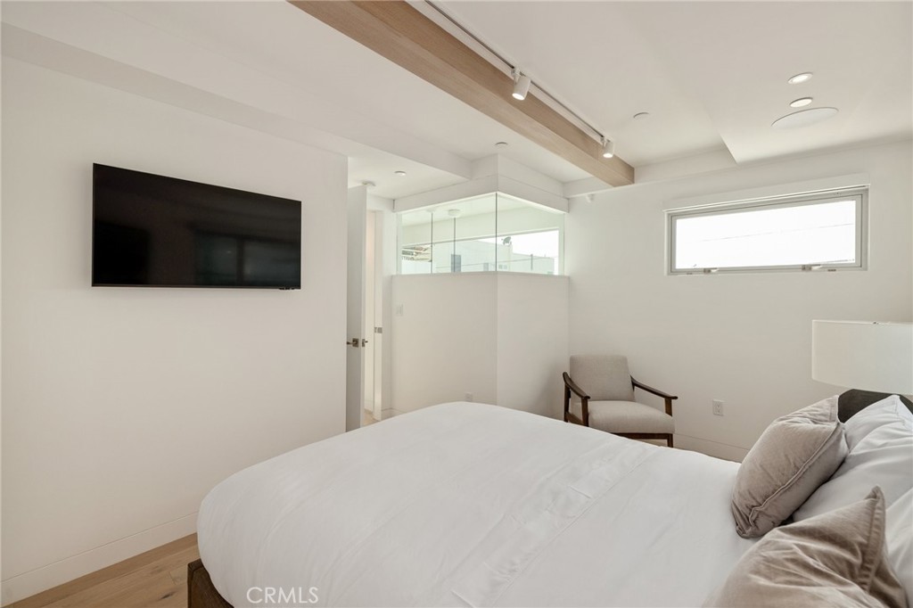4310 Ocean Drive Manhattan Beach, CA 90266 - Photo 37 of 54 a bedroom with a bed a flat screen tv and a window