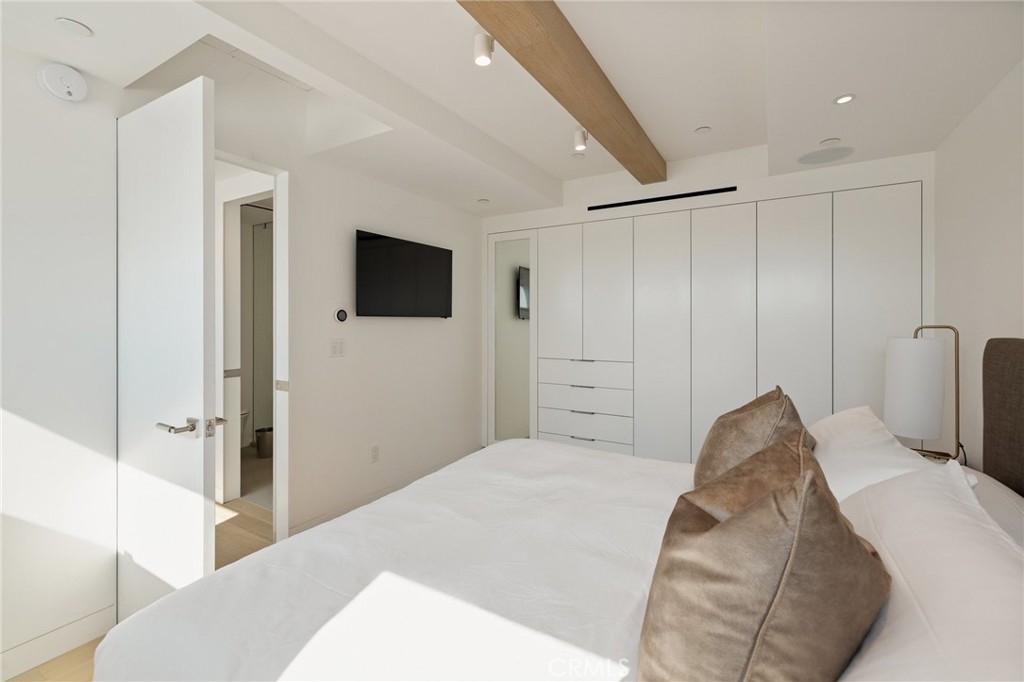 4310 Ocean Drive Manhattan Beach, CA 90266 - Photo 38 of 54 a bedroom with a bed and a flat screen tv