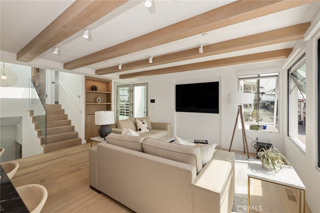 4310 Ocean Drive Manhattan Beach, CA 90266 - Photo 4 of 54 a living room with furniture a flat screen tv and a view of kitchen
