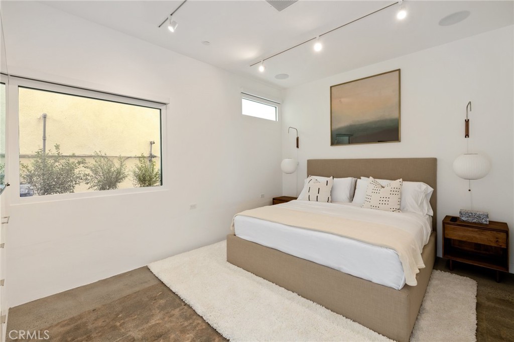 4310 Ocean Drive Manhattan Beach, CA 90266 - Photo 47 of 54 a bedroom with a large bed and a window