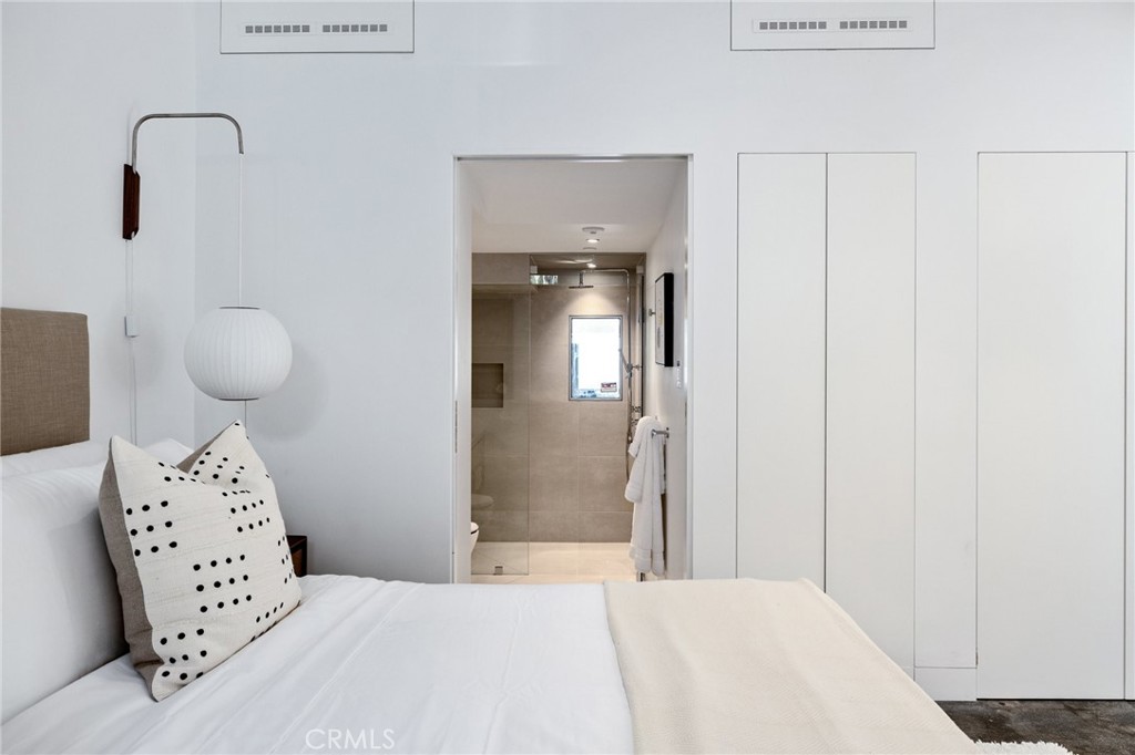 4310 Ocean Drive Manhattan Beach, CA 90266 - Photo 50 of 54 a bedroom with a bed and a mirror