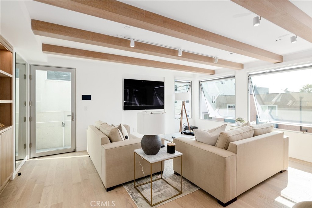 4310 Ocean Drive Manhattan Beach, CA 90266 - Photo 6 of 54 a living room with furniture and a flat screen tv