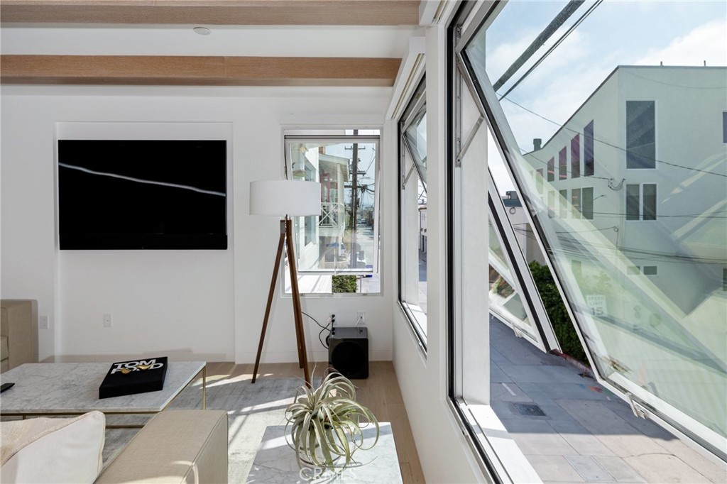 4310 Ocean Drive Manhattan Beach, CA 90266 - Photo 8 of 54 a living room with a flat screen tv and a fireplace