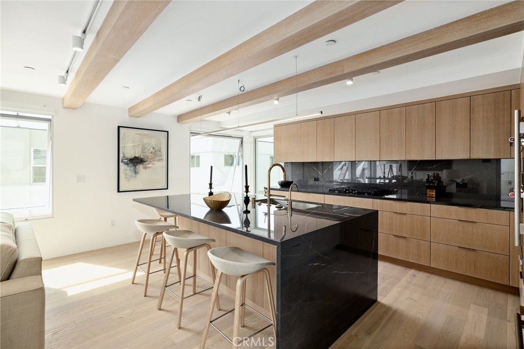 4310 Ocean Drive Manhattan Beach, CA 90266 - Photo 10 of 54 a kitchen with stainless steel appliances kitchen island granite countertop a sink and cabinets