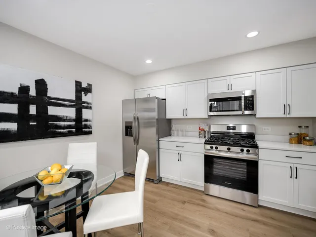 a kitchen with stainless steel appliances a stove refrigerator sink and microwave