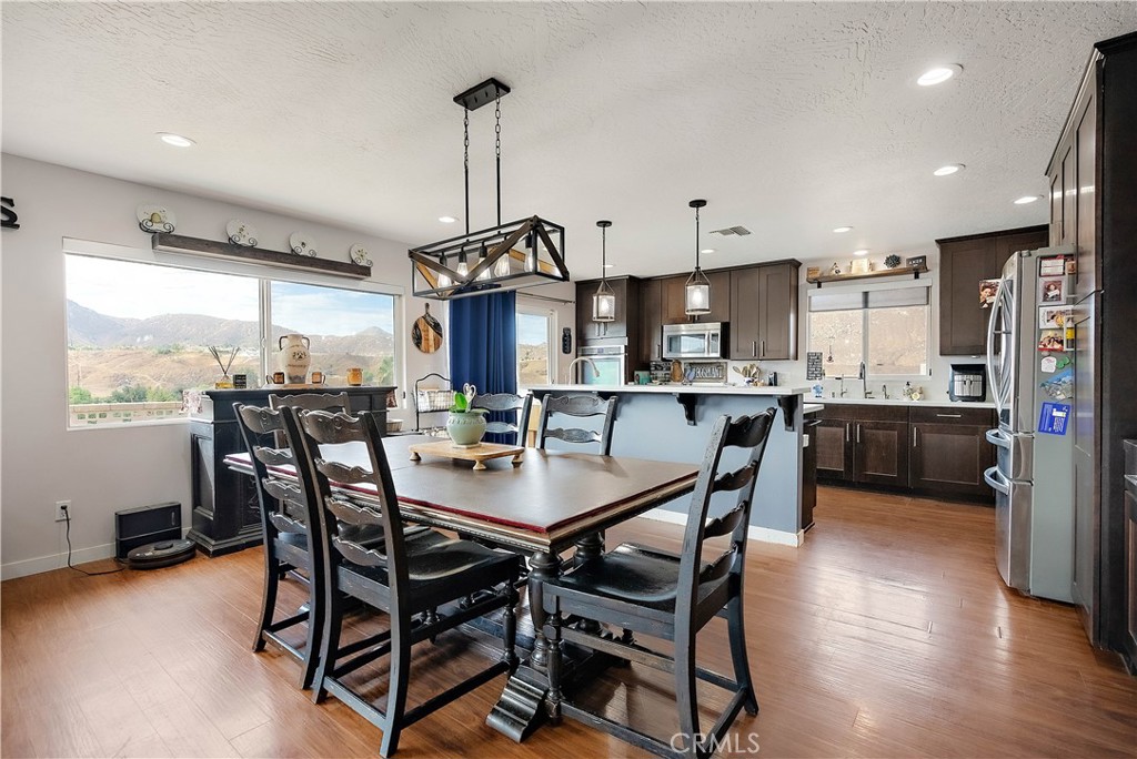 24444 Scotch Lane Colton, CA 92324 - Photo 12 of 43 a view of a dining room and livingroom with furniture wooden floor a chandelier