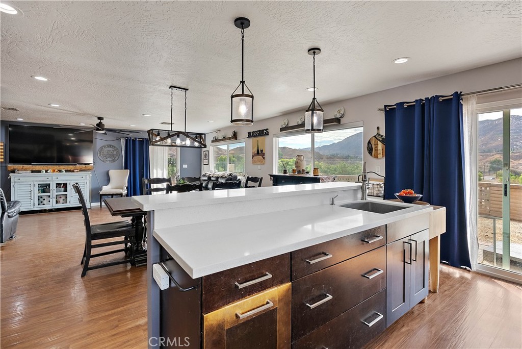 24444 Scotch Lane Colton, CA 92324 - Photo 16 of 43 a kitchen with a stove a refrigerator and a wooden floor