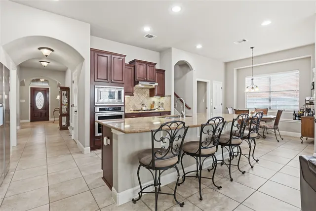 a large kitchen with a table and chairs