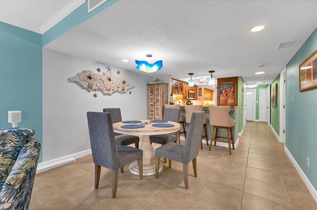8776 Midnight Pass Road, Unit C107 Sarasota, FL 34242 - Photo 13 of 47 a view of a dining room with furniture