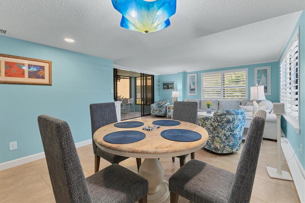 8776 Midnight Pass Road, Unit C107 Sarasota, FL 34242 - Photo 15 of 47 a view of a dining room with furniture