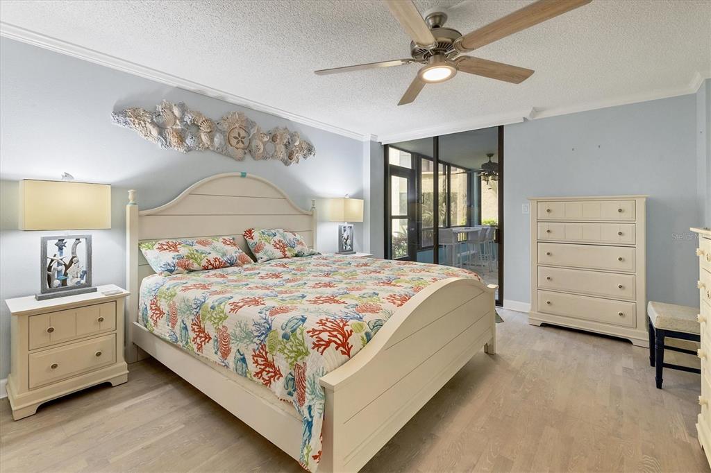 8776 Midnight Pass Road, Unit C107 Sarasota, FL 34242 - Photo 16 of 47 a bedroom with a bed and a dresser
