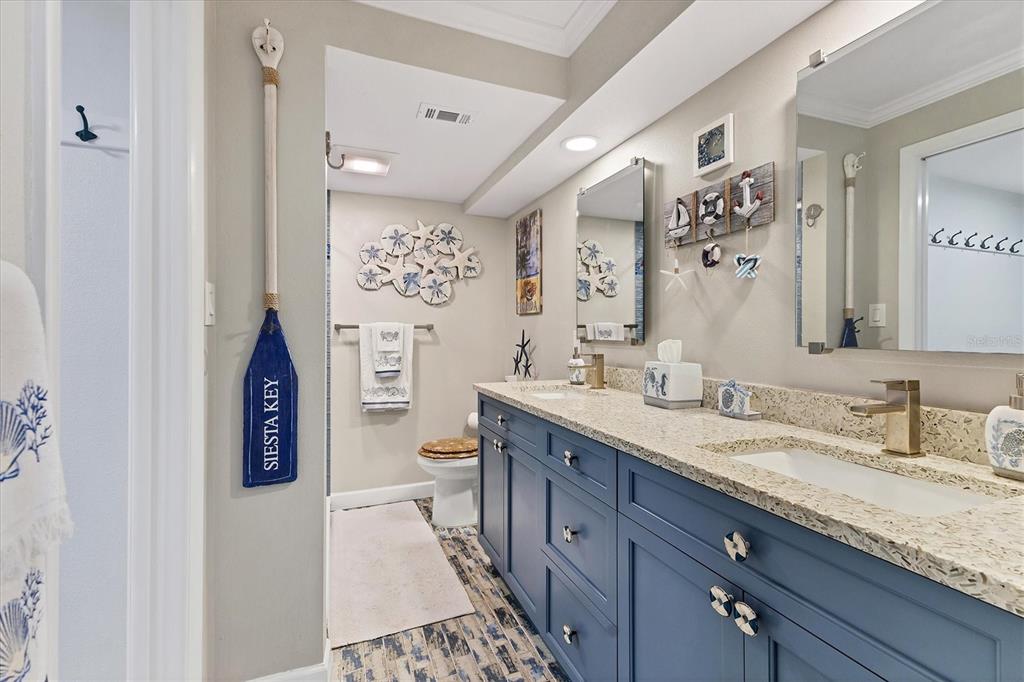 8776 Midnight Pass Road, Unit C107 Sarasota, FL 34242 - Photo 19 of 47 a spacious bathroom with a granite countertop sink and a mirror