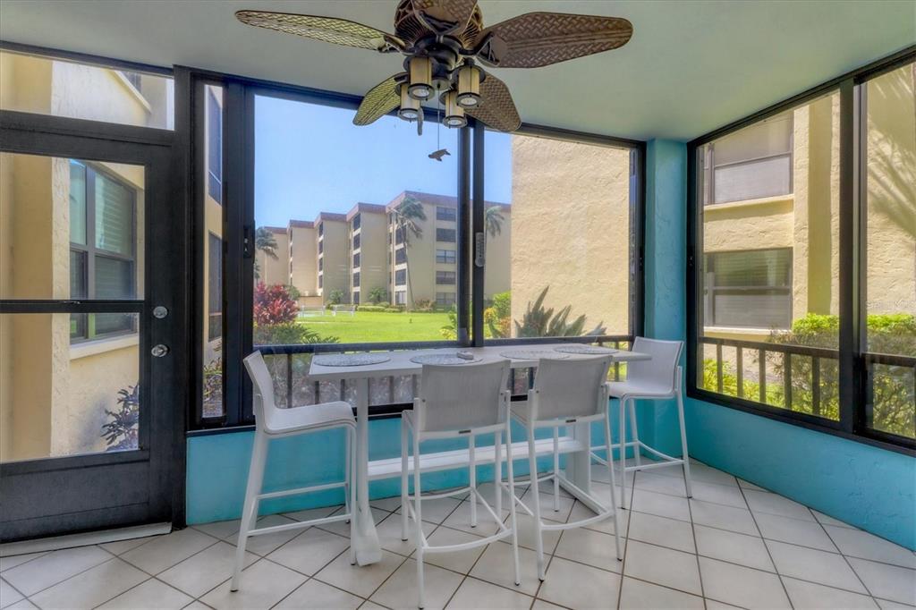8776 Midnight Pass Road, Unit C107 Sarasota, FL 34242 - Photo 25 of 47 a view of a dining room with furniture window and outside view