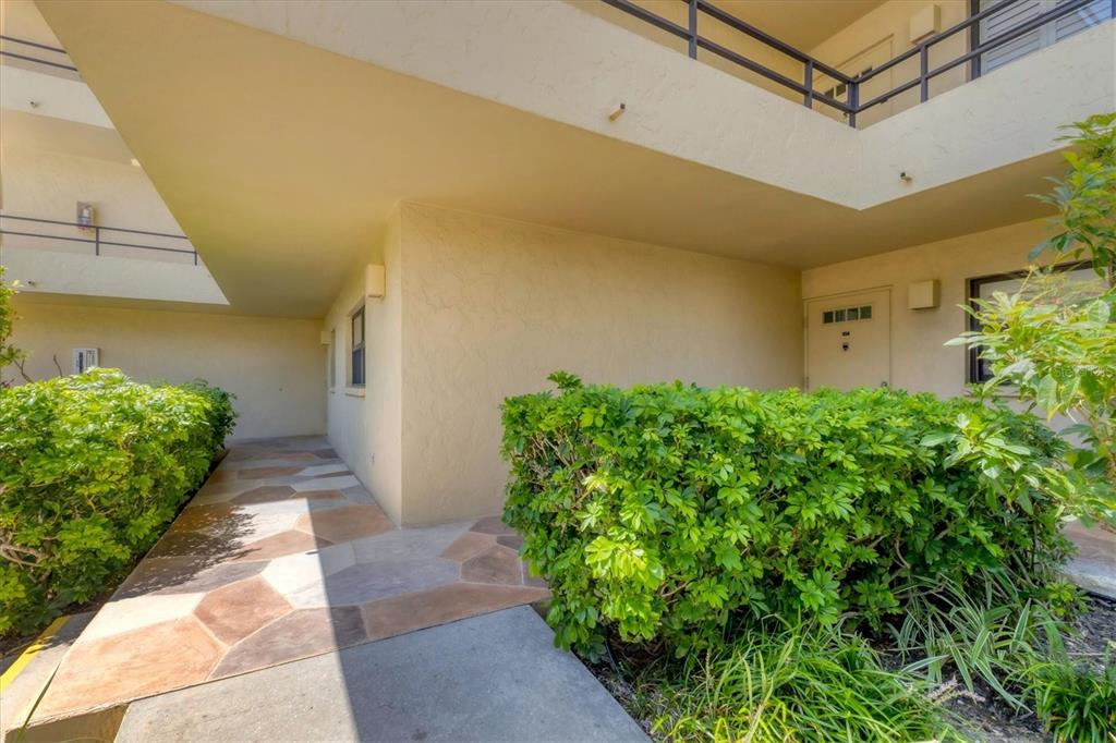 8776 Midnight Pass Road, Unit C107 Sarasota, FL 34242 - Photo 32 of 47 a view of a pathway with a yard
