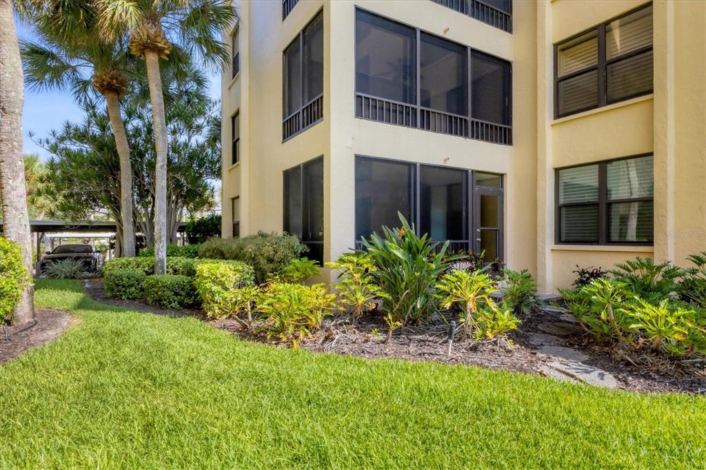 8776 Midnight Pass Road, Unit C107 Sarasota, FL 34242 - Photo 33 of 47 a flower garden in front of a house