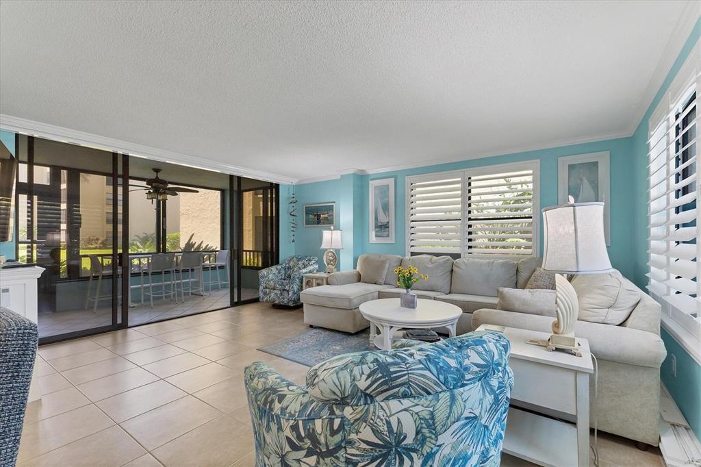 8776 Midnight Pass Road, Unit C107 Sarasota, FL 34242 - Photo 6 of 47 a living room with furniture and large windows