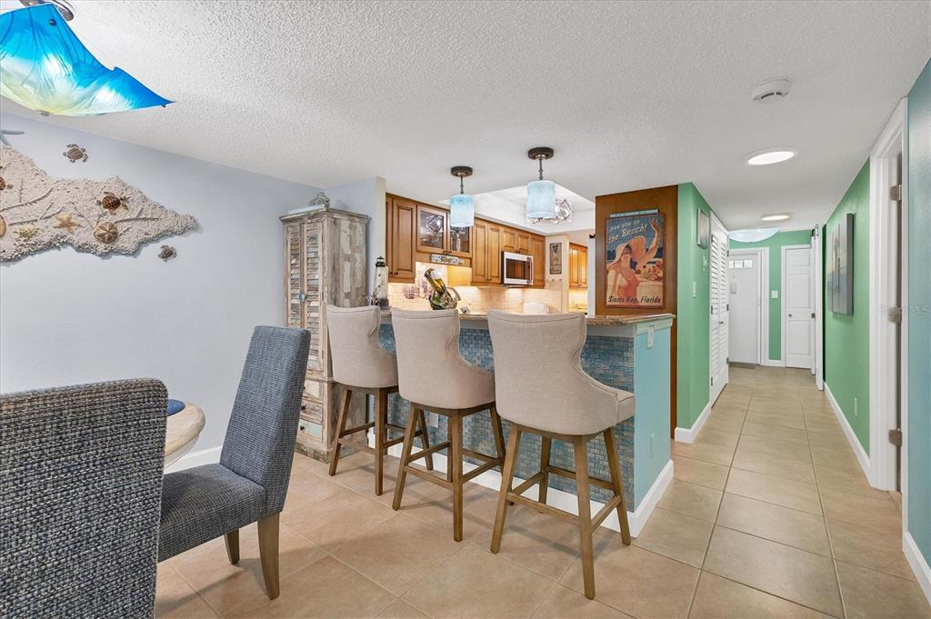 8776 Midnight Pass Road, Unit C107 Sarasota, FL 34242 - Photo 9 of 47 a view of a dining room with furniture