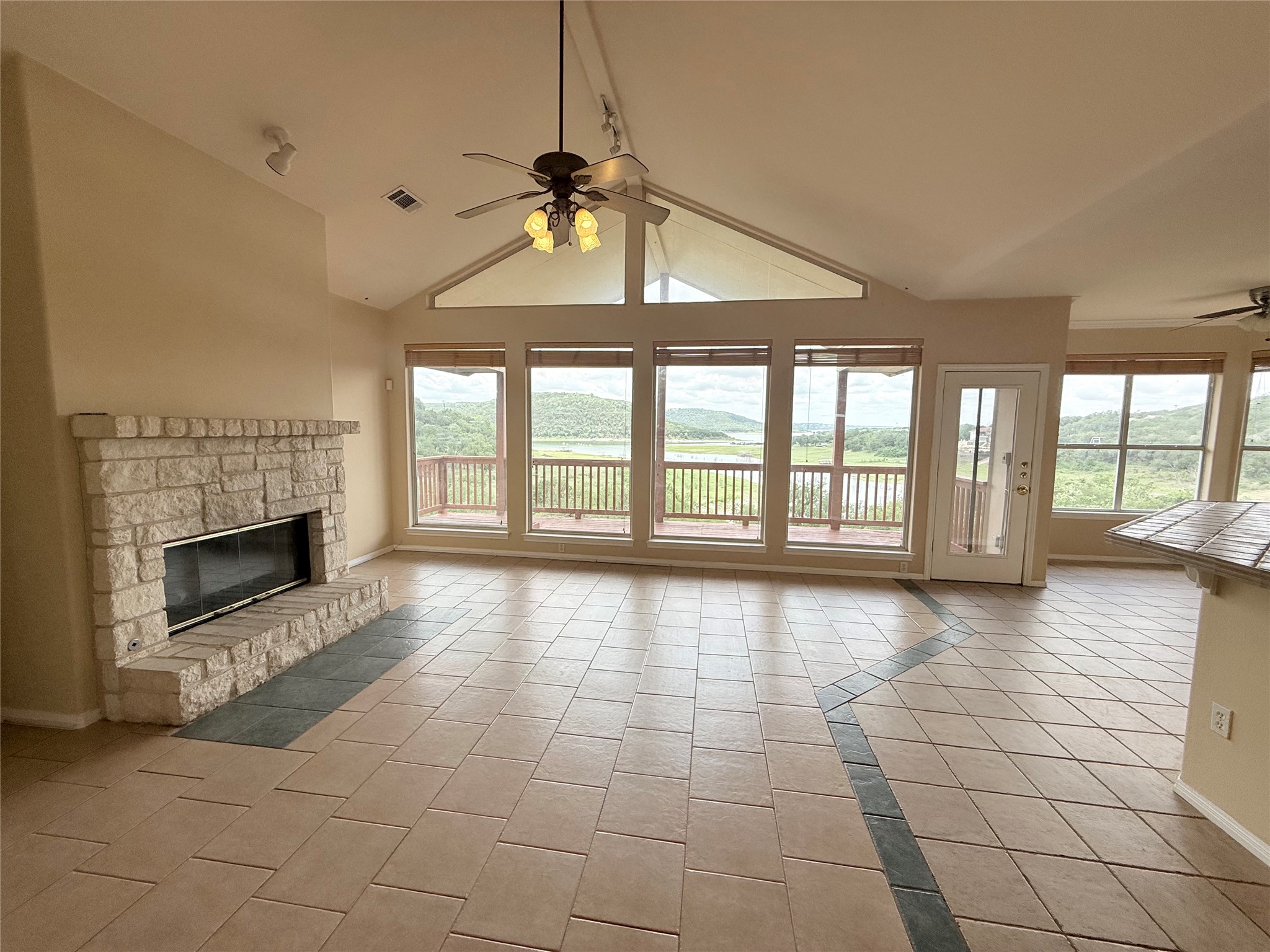 13612 Bullick Hollow Road Austin, TX 78726 - Photo 5 of 34 a view of an empty room with a fireplace and a floor to ceiling window