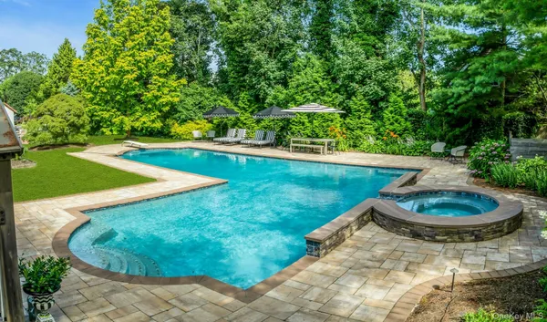 a backyard of a house with a yard and outdoor seating