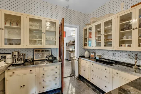 a kitchen with granite countertop a sink and cabinets