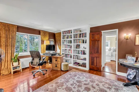 a view of a livingroom with workspace and a window