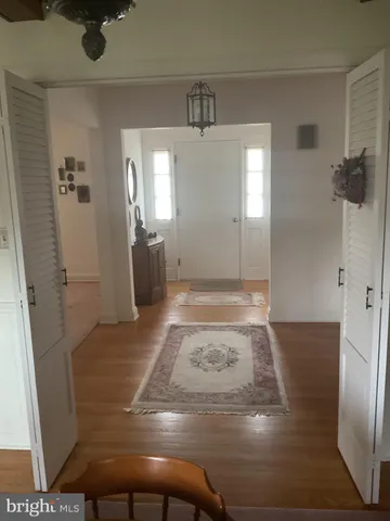 a view of a hallway view with wooden floor and staircase