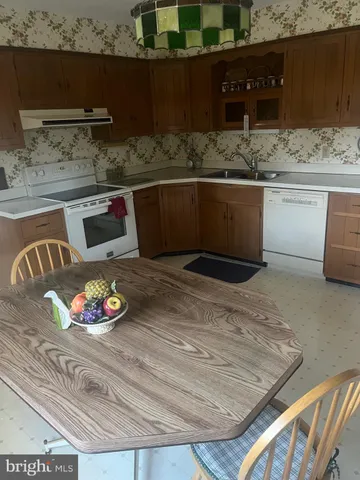 a view of kitchen sink and wooden floor