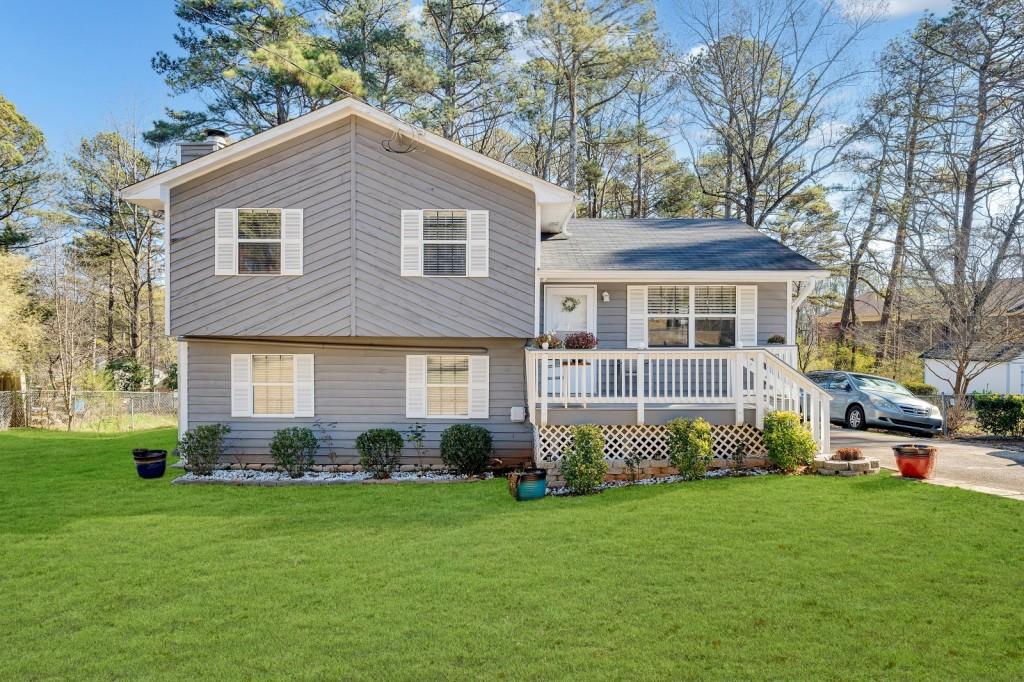 1364 Monfort Road Lawrenceville, GA 30046 - Photo 1 of 1 a front view of a house with garden