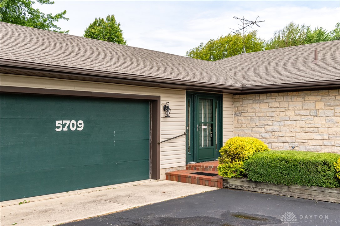 This charming home offers a garage and an inviting entrance, perfect for comfortable living.