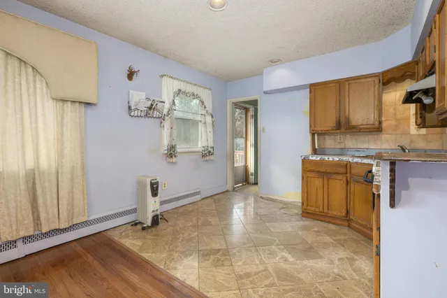 a view of a kitchen with wooden floor and a sink